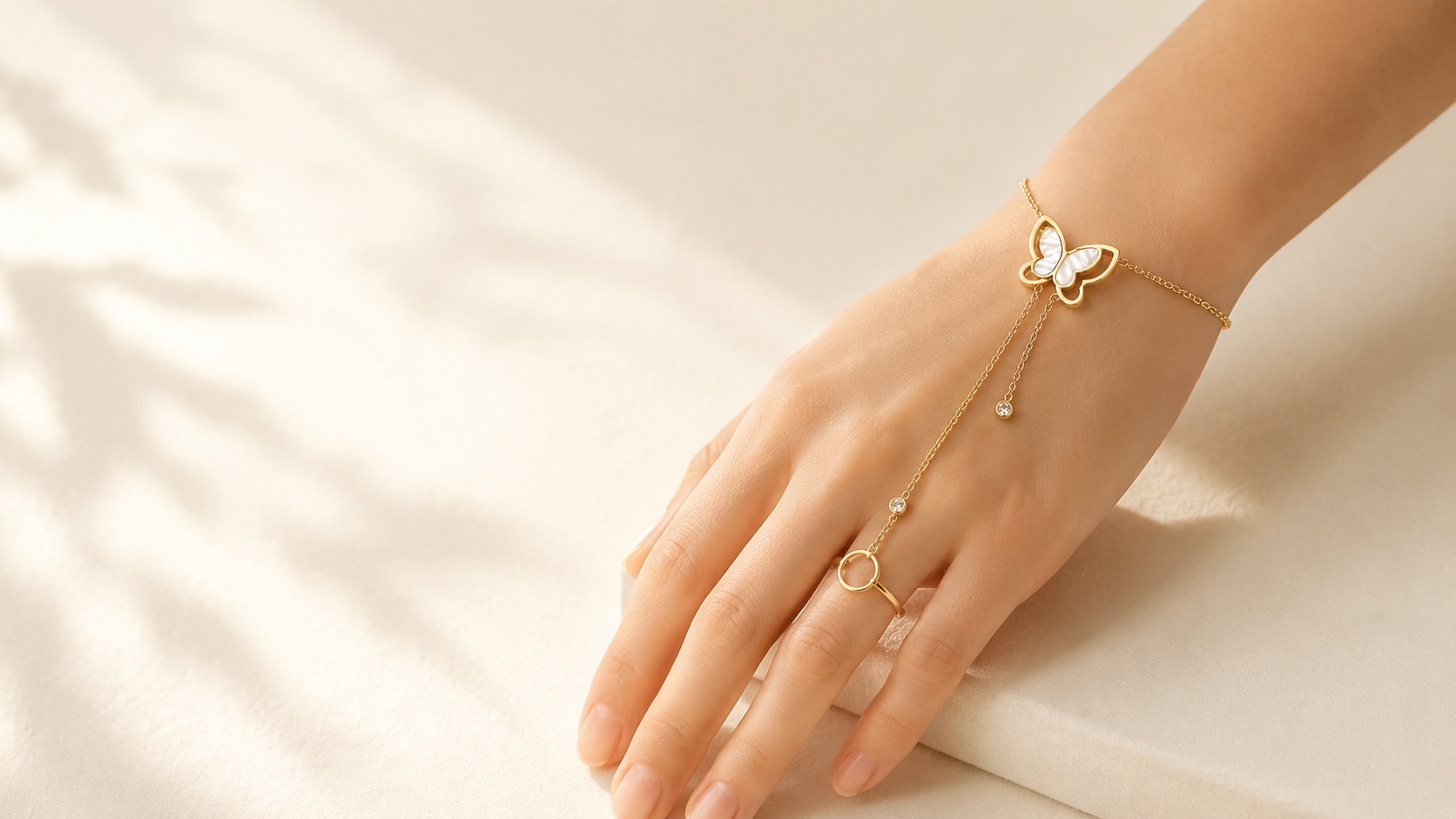 The Editorial hand chain with butterfly detail near the wrist.